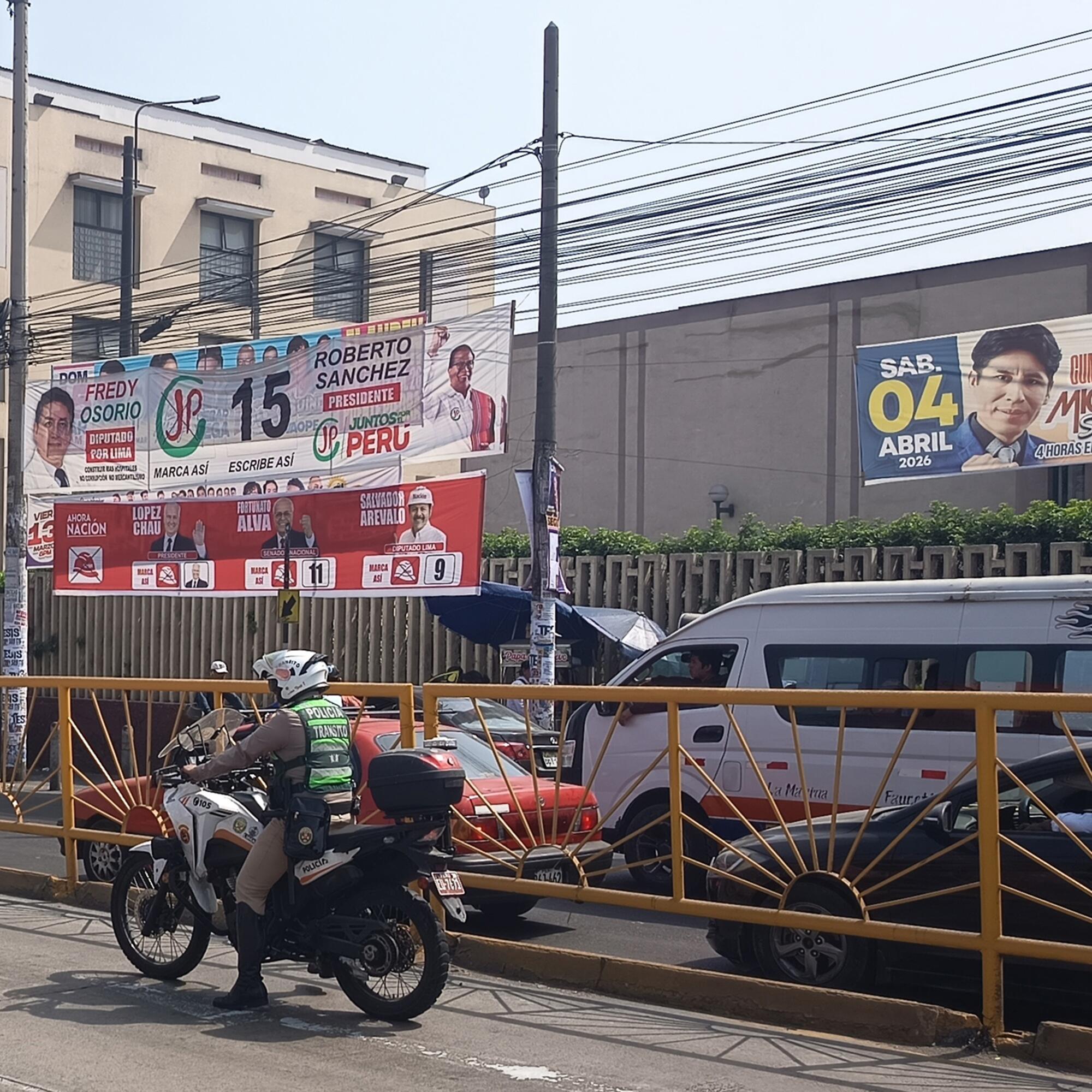 Un policía, frente a la propaganda electoral de Juntos por el Perú y Ahora Nación, las dos principales formaciones de izquierda.