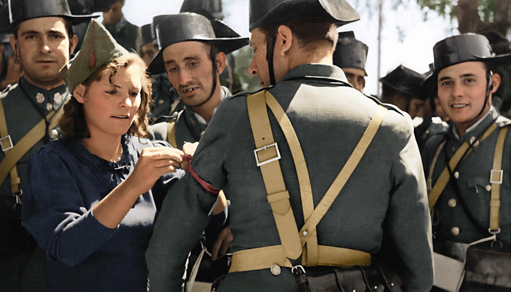 Miliciana coloca un lazo rojo a guardias civiles leales a la República.