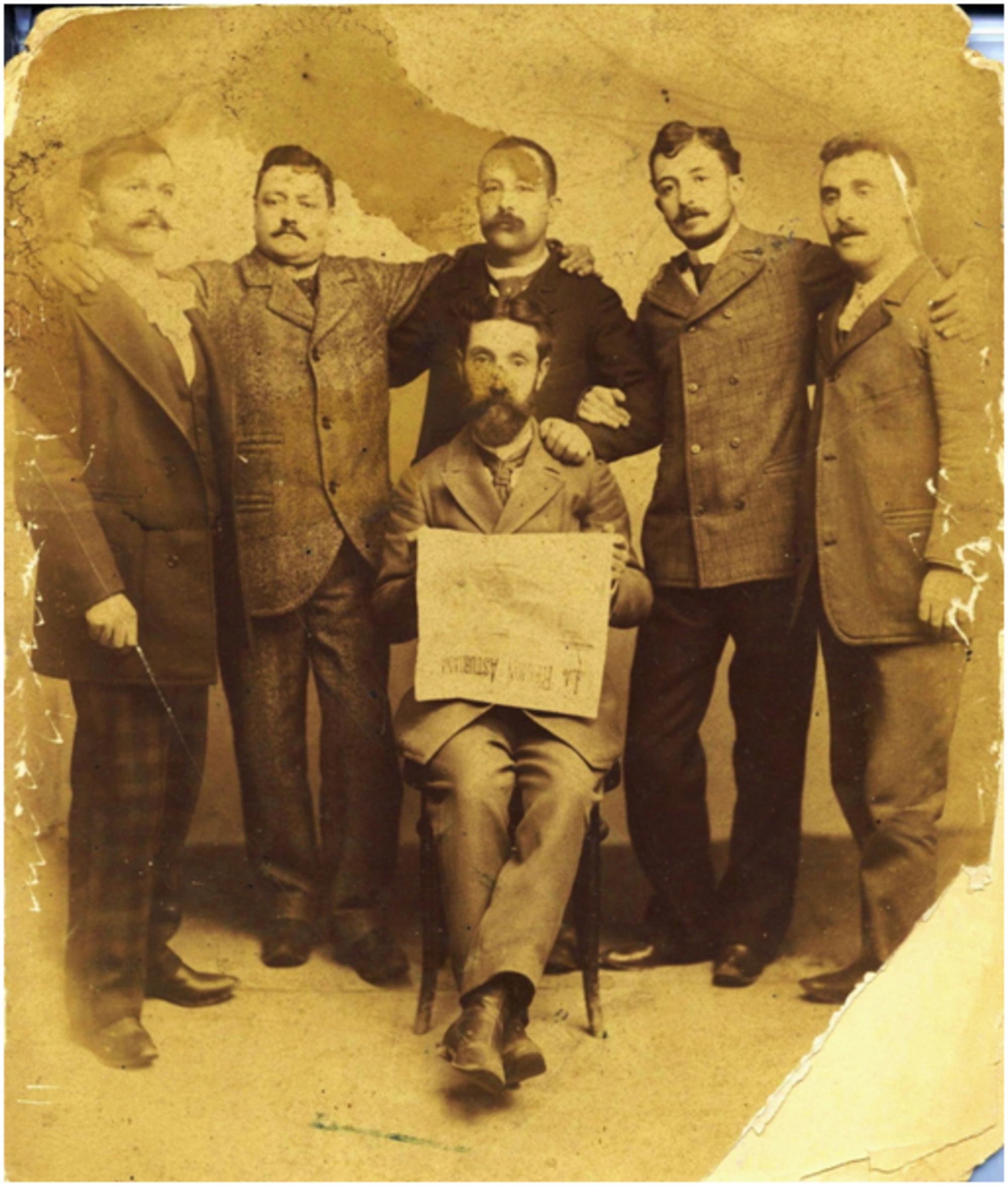 Eladio Carreño, sentado, con un ejemplar de "La región asturiana"